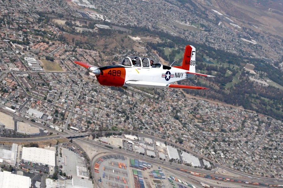 Air-to-air shot of a Navy T-34 trainer flying over Los Angeles