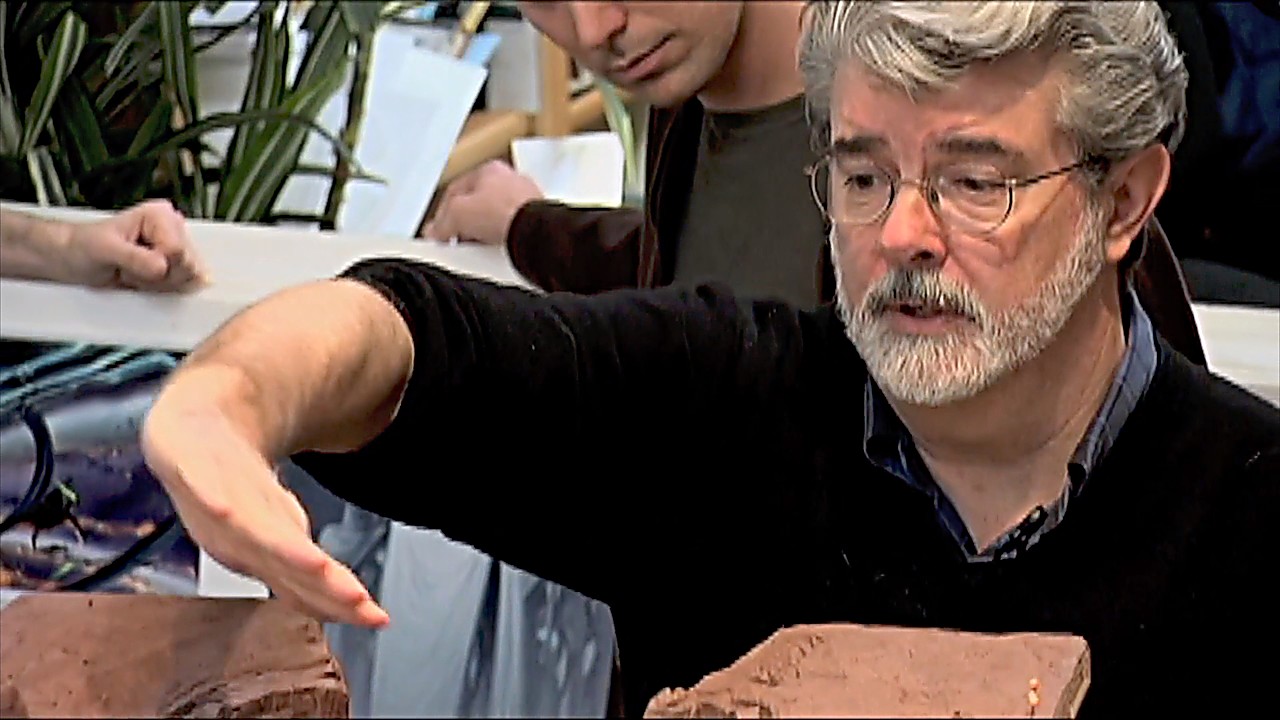 George Lucas gesturing over a set model during Star Wars: Episode III production